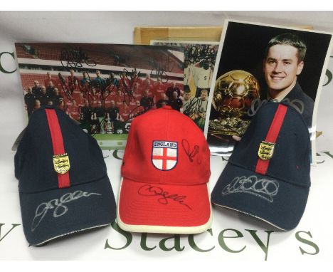 A collection of signed football related ephemera comprising three baseball caps signed by David Beckham, Michael Owen and Pau