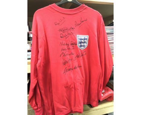 A 1966 England Football World Cup signed shirt, the replica shirt signed by 10 players in black felt (does not include Bobby 