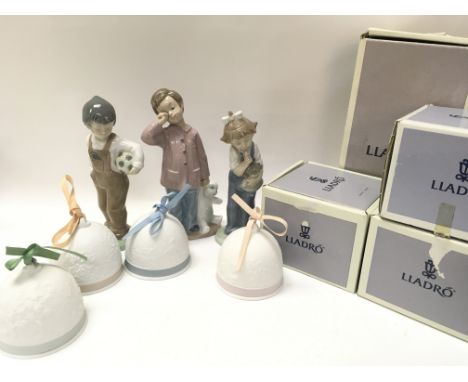 A Collection of boxed porcelain Lladro Christmas tree bell decorations and three porcelain Nao figures. This lot cannot be po