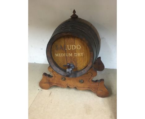 A vintage spirit barrel on stand , Saludo medium dry. Approximately 39cm tall