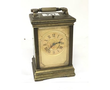 An Edwardian brass cased carriage clock strike repeat with a gilded dial the movement striking on gongs. Seen working strike 