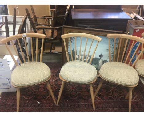 A set of four blonde Ercol dinning chairs stick back with original seat covers (4)