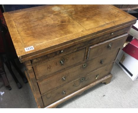 A Georgian walnut bachelors chest with brushing slide fitted with two short and two long drawers. On bracket feet