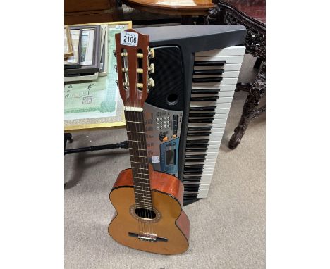 A Yamaha PSR 17 Keyboard and a Spanish guitar. Shipping Category D NO RESERVE