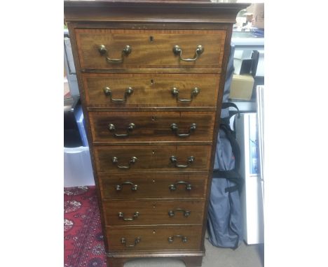 A Edwardian mahogany wellington style chest with cross banding fitted with Seven drawers on bracket feet. 40 x37 cm height 11