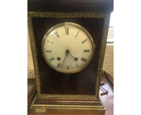 A 19h century French silk suspension table clock the bur and ormaloo cases inset with dial with Roman numerals the movement s