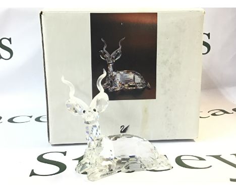 A boxed Swarovski Africa 1994 Kudu Crystal glass figure. Approximately 9.5cm tall. No obvious damage or restoration This lot 