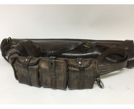 A Military leather belt magazine holster with several compartments and a leather gun case and one other leather magazine case