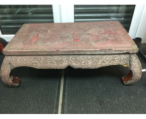 A highly decorative cinnabar low table, top diameter approx 90cm. Some damage. Shipping category D. NO RESERVE