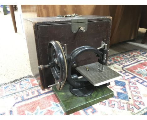 A vintage cased hand crank cast iron sewing machine. This lot cannot be posted