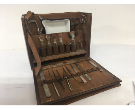 A Vintage leather surgeon case fitted with medical instruments and a Vintage typewriter and a typewriter.