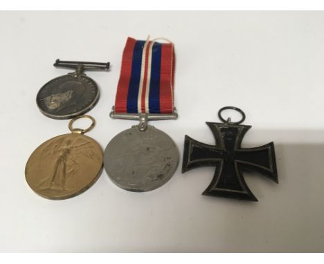 A German Imperial iron Cross 1813/1914. Two First World War medals awarded to 427 Pte G Barker midd x R also one other awarde