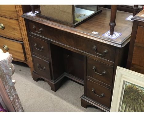 A George III Mahogany kneehole desk fitted with one long drawer and graduating drawers on bracket feet. 90cmx50cm height 72cm