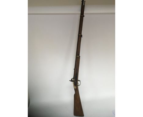 An Antique percussion rifle with three brass barrel and rings muzzle load with ram rod.