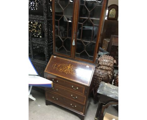 A Edwardian mahogany inlaid bureau bookcase with a pair of glazed doors above a fall front with three drawers under.