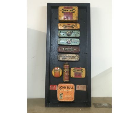 A framed display of vintage bike puncture repair tins. Postage category C