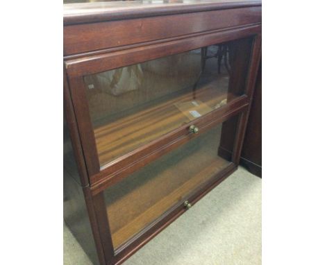  A Quality Early Victorian Walnut credenza with a raised mirrored back with gilded pillar supports above glazed doors with gl