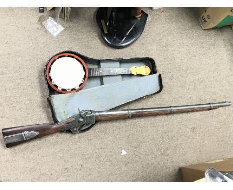 A replica American civil war carbine rifle and a cased banjolele.