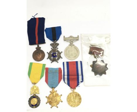 A Collection of military medals including a China 1954 merit, Polish peoples public medal, Belgium Telegraphic Service medal,