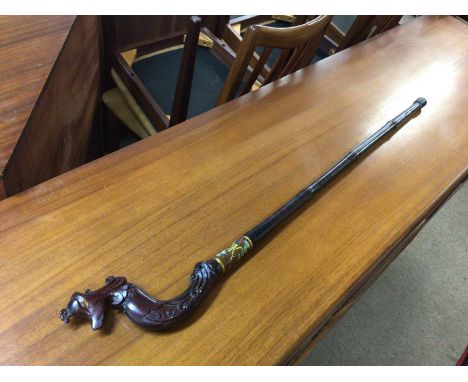 A Chinese wooden walking stick with a phoenix head shaped handle and a cloisonne collar. No reserve