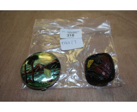Enamelled white metal compact, lake scene, and oriental painted papier mache brooch