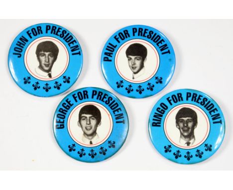 THE BEATLES.  A SET OF FOUR PRINTED METAL PORTRAIT BADGES, 5.5CM DIAM