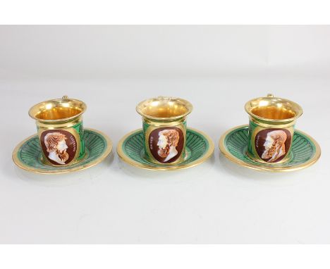 Three porcelain green and gilt coffee cups, each painted with oval cameos of classical figures