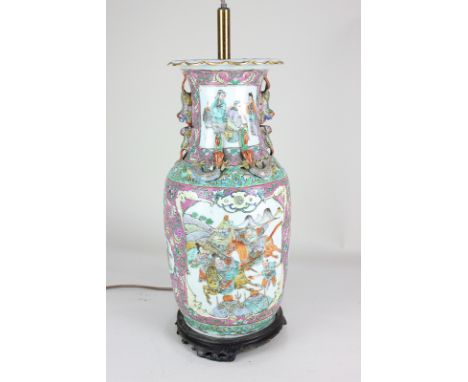 A Chinese porcelain baluster vase converted to a table lamp, decorated with panels of figures amongst scrolling foliate decor