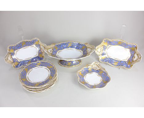 A Spode Felspar porcelain part dessert service, decorated in gilt on a band of blue ground with leaves and flower sprigs, wit