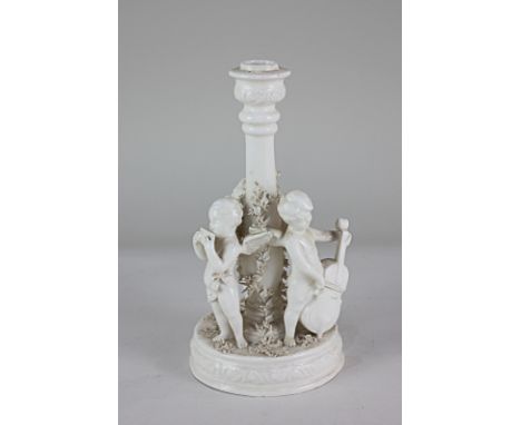 A blanc de chine candlestick with three winged cherubs playing musical instruments and floral bocage decoration on circular b