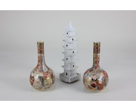 A pair of Japanese Satsuma ware bottle vases, 15.5cm high, together with a white glazed ceramic model of a pagoda, 20.5cm (a/