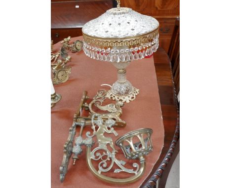 An Edwardian griffin wall bracket in gilt brass; a cherub wall bracket; a glass and brass table lamp with chandelier shade