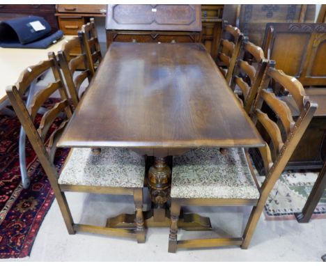 An oak Jacobean style dining suite comprising rectangular refectory table, 6 ladder back chairs, court cupboard and corner cu