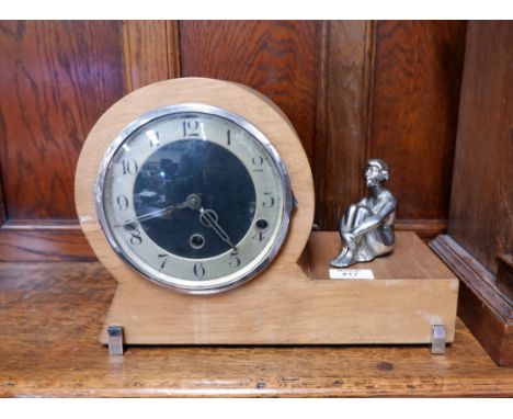 An Art Deco mantel clock, oak and chrome cased with seated chrome figure