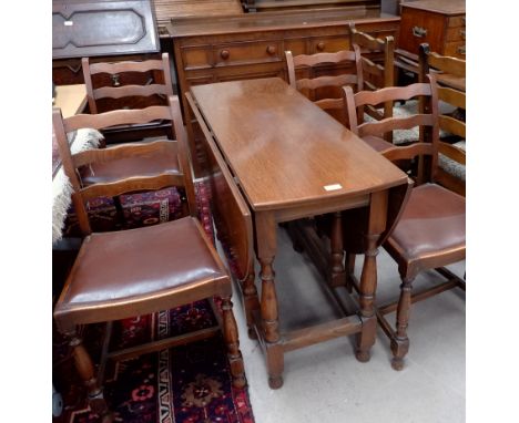 A 1940's Ercol oak and elm dining suite comprising sideboard, oval drop leaf table and 4 chairs