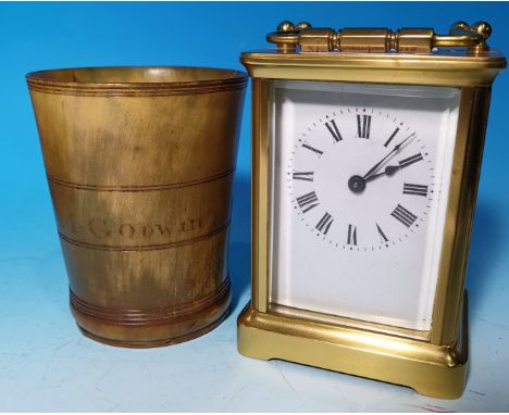 An early 20th century brass carriage clock with timepiece movement; a 19th century horn beaker incised 'M Goodwin'