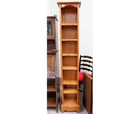 An oak 7 height narrow shelf unit