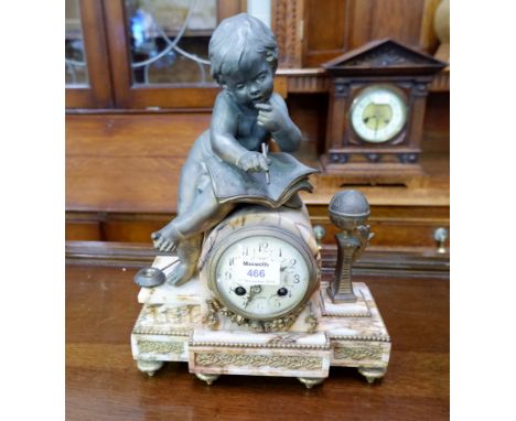 A 19th century French variegated marble mantel clock surmounted by a bronzed figure of a cherub, writing, striking French mov