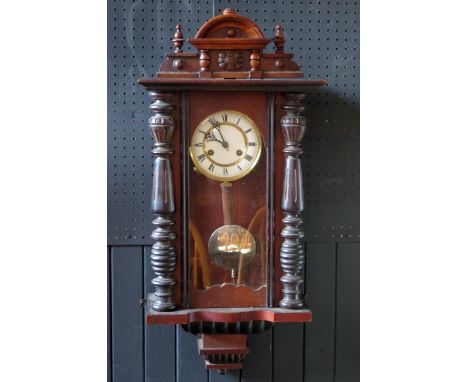 A Vienna style regulator wall clock the case with arched pediment, turned columns and glazed door, the movement with two-stag