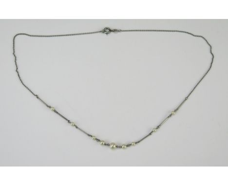 A 16.75" Platinum and Pearl Necklace (untested), largest pearl c. 5.5mm, 2.2g 
