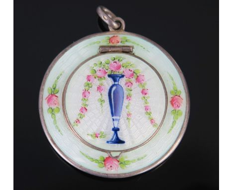 A continental silver and enamel compact, bears import marks for London, 1913, of circular form, the lid decorated with a vase