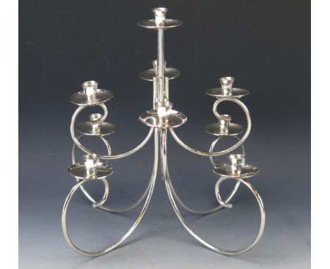 A modernist silver plated nine light dual purpose candelabra, on swept branches with urn-shaped nozzles, 27cm high. 