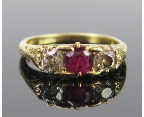 A Ruby and Diamond Three Stone Ring in an unmarked high carat gold setting, 5mm ruby, EDW .42ct, size J.5, 3.5g 