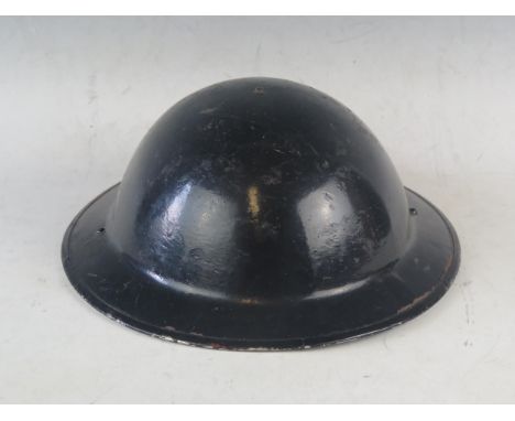 A WW2 period black painted steel helmet, with liner. 