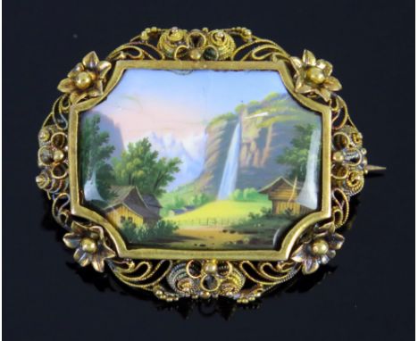 A 19th Century Enamel Brooch in a gold or gilt filigree  setting, the central panel decorated with an alpine waterfall scene,