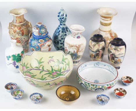 A mixed collection of Chinese and Japanese ceramics including vases bowls sake bowls, crackle glaze vase decorated with samur