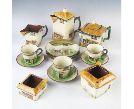 A Watcombe part tea service, decorated as country cottages includes tea pot, cream jug, hot water jug, three cups, three sauc