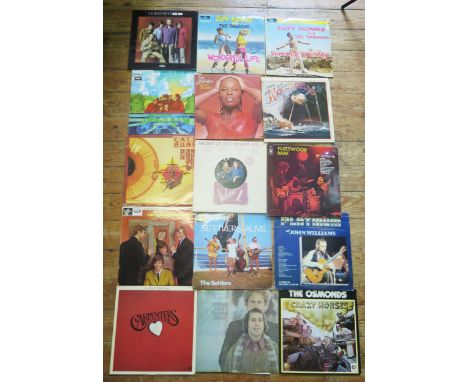 A collection of 33RPM records including the Beatles, jazz artists including Brubeck, Miles Davis, Oscar Peterson, Woody Herma