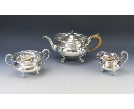An Edward VII silver three-piece tea service, maker Goldsmiths &amp; Silversmiths Co Ltd, London, 1902, of circular form with