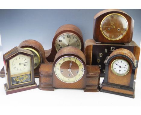 Seven assorted mantel clocks and clock cases, most of arched outline all incomplete and in need of attention. 